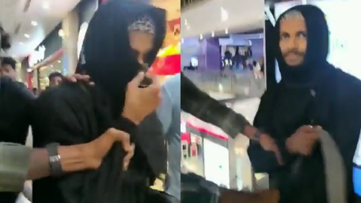 Screengrab of video showing burqa-clad man caught in mall. () Photo Credit: X/@shuja_2006)